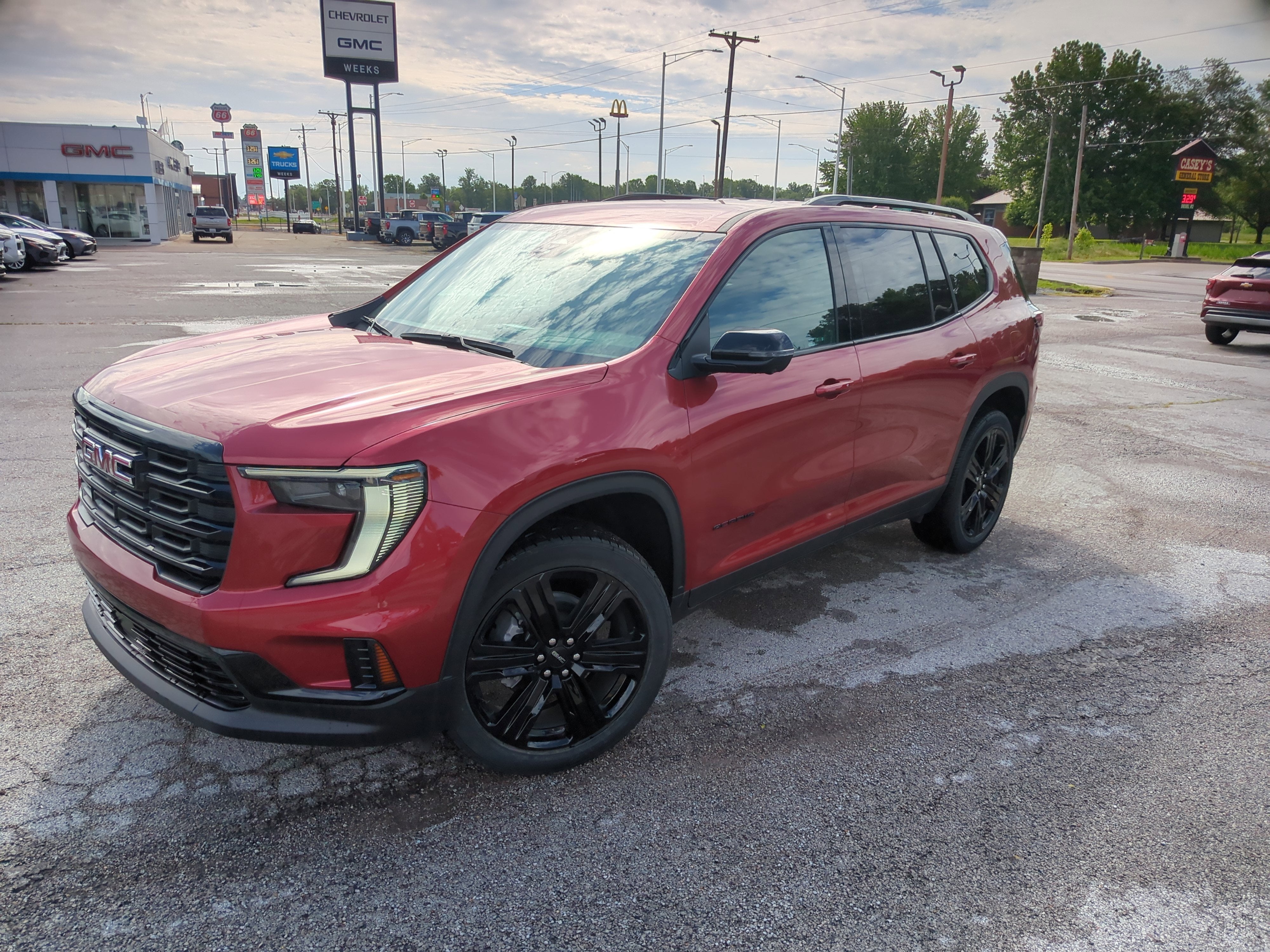 2025 GMC Acadia Elevation in Volcanic Red Tintcoat — front three-quarter view